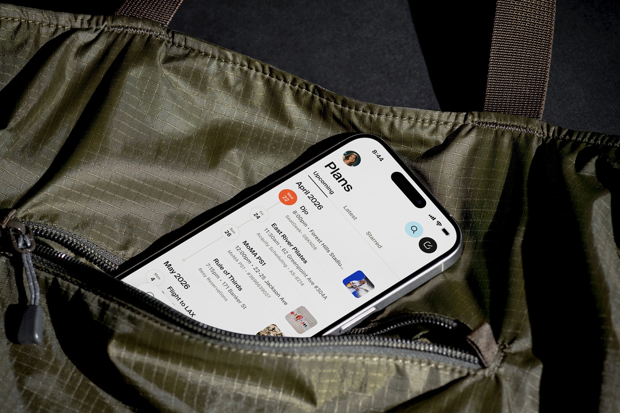 A phone peaking out of a bag, showing the plans screen