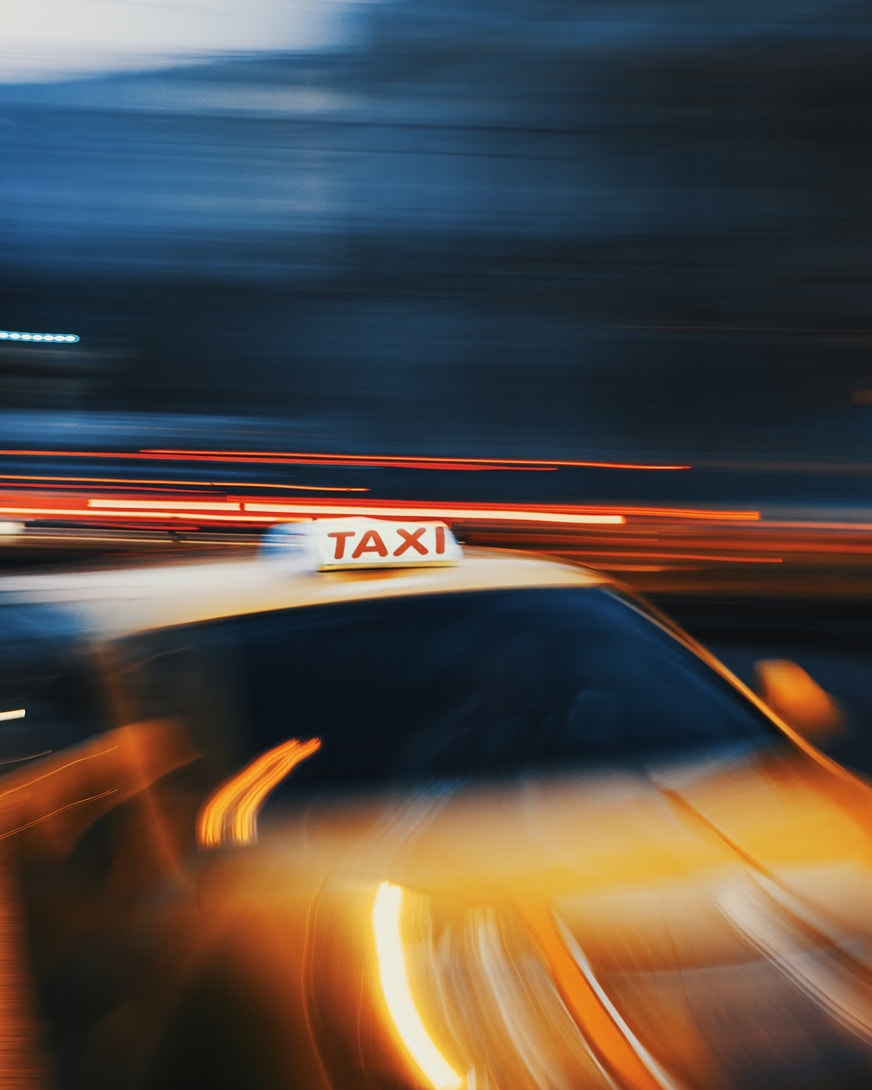 A blurred photo of a taxi at night