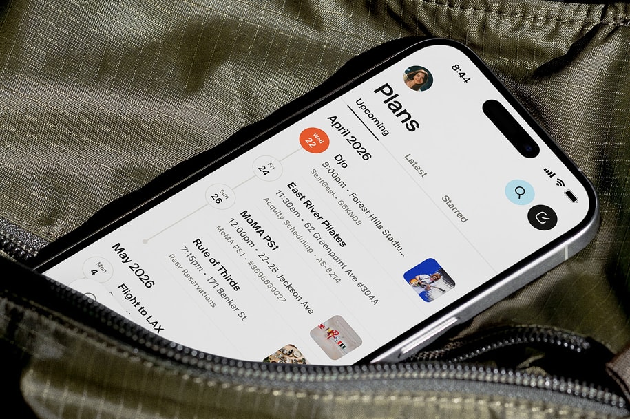 A phone peaking out of a bag, showing the plans screen