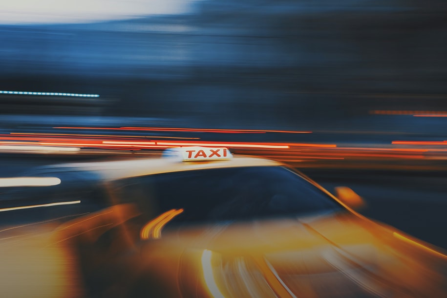 A blurred photo of a taxi at night
